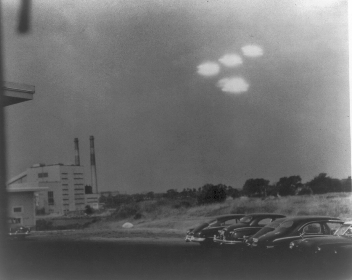 A photograph taken by U.S. Coast Guard photographer Shell R. Alpert on 16 July 1952, showing four bright objects in V formation over the Salem, Massachusetts Air Station.